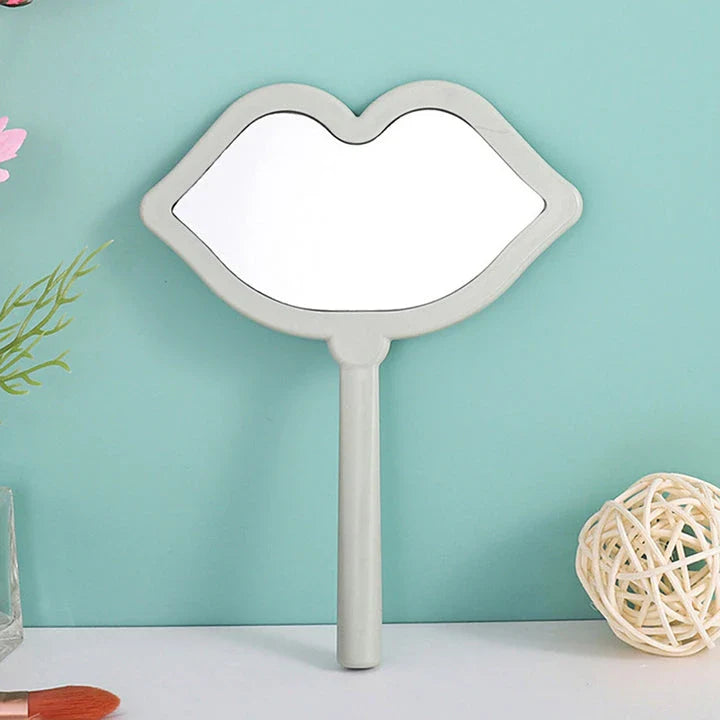Lip-shaped handheld makeup mirror with a comfortable ergonomic handle for precise on-the-go touch-ups
