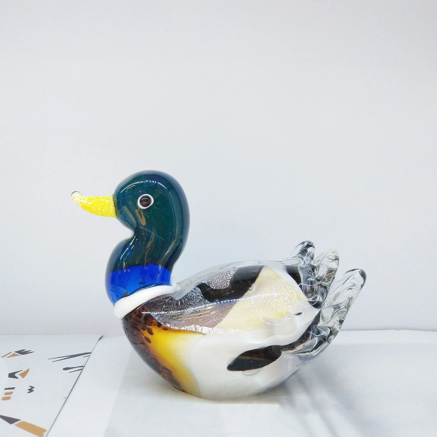 Handcrafted glass ornament in the shape of a Mandarin duck with vibrant colours and intricate details
