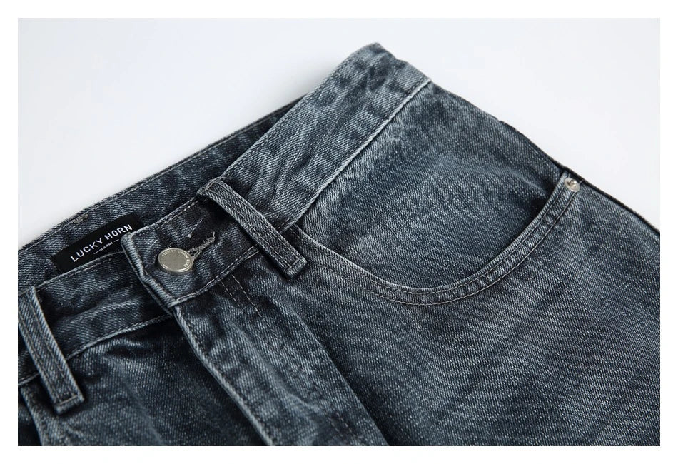 A pair of stylish retro-inspired Japanese jeans in black and grey, featuring a mid-rise waist and straight leg silhouette for a flattering, comfortable fit.