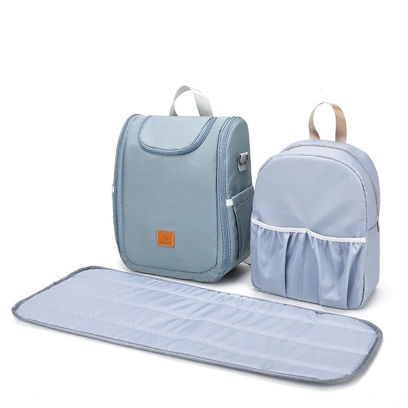 Versatile baby changing backpack with convertible crib bed, large storage capacity, and insulated feeding bottle compartment