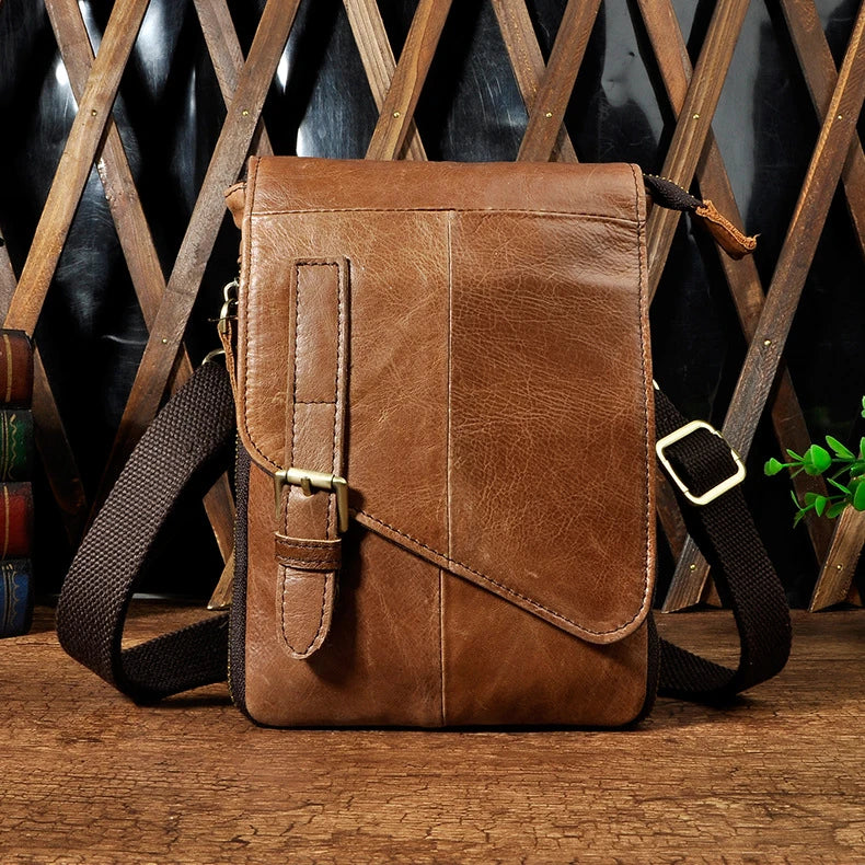 Premium cowhide leather one-shoulder crossbody bag in light grey colour with adjustable strap and zipper pocket