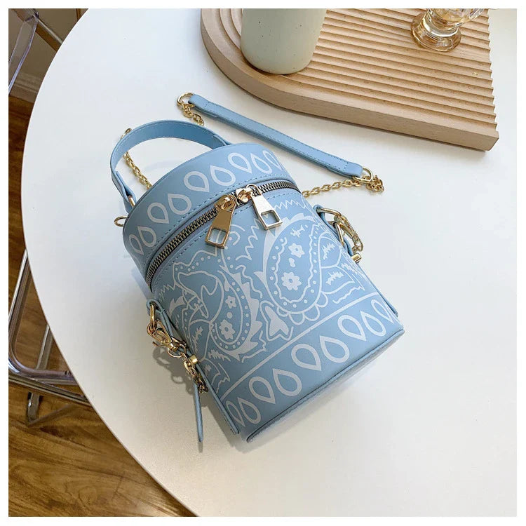 Premium PU leather bucket bag in a variety of classic and contemporary colours, featuring a spacious main compartment, adjustable shoulder strap, and sophisticated British-inspired design.