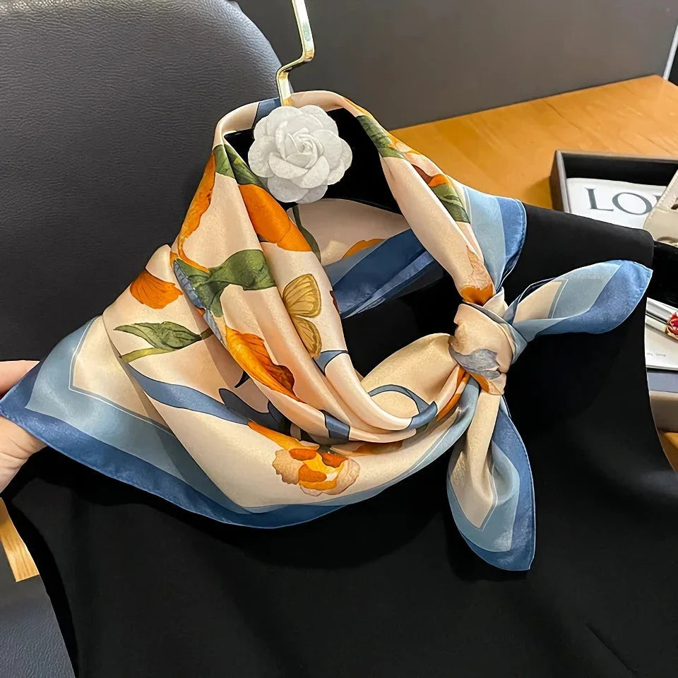 Luxurious floral 100% silk square scarf for women, featuring a charming print and versatile design.