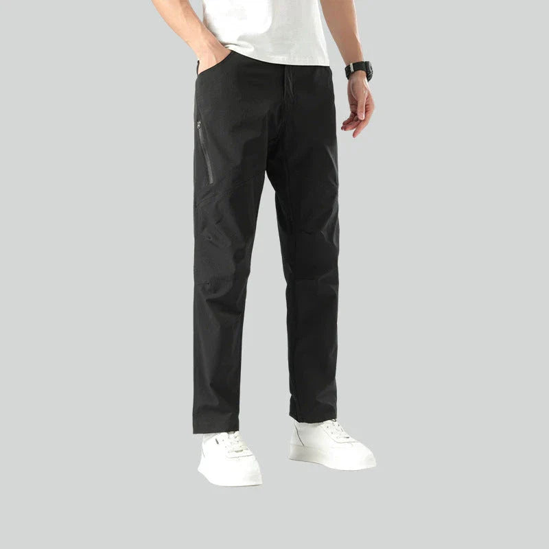 Weatherproof outdoor trousers for men in black, gray, and green colours with adjustable waistband and reinforced panels