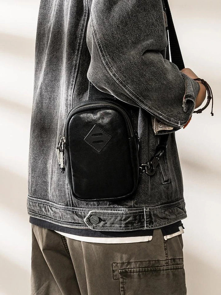 Premium black leather chest bag with zip closure, handcrafted in the United Kingdom for style and functionality