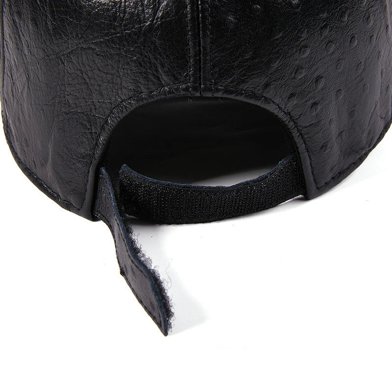 A stylish men's baseball cap made from warm, first-layer cowhide leather with an eye-catching ostrich pattern design.