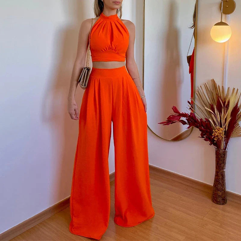 A stylish two-piece set with a halter-neck top and relaxed, high-waisted trousers in a range of sophisticated colours