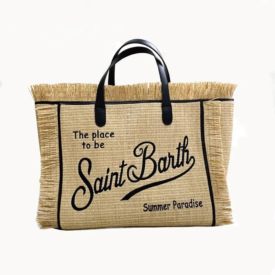 Stylish embroidered straw tote bag with playful tassels, perfect for summer outings and beach adventures.