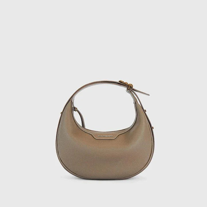 Stylish crescent-shaped leather crossbody bag with soft, supple texture for everyday elegance