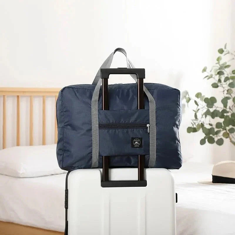 Premium foldable travel duffel bag in a solid colour design, with a large capacity and lightweight construction for women's travel needs.