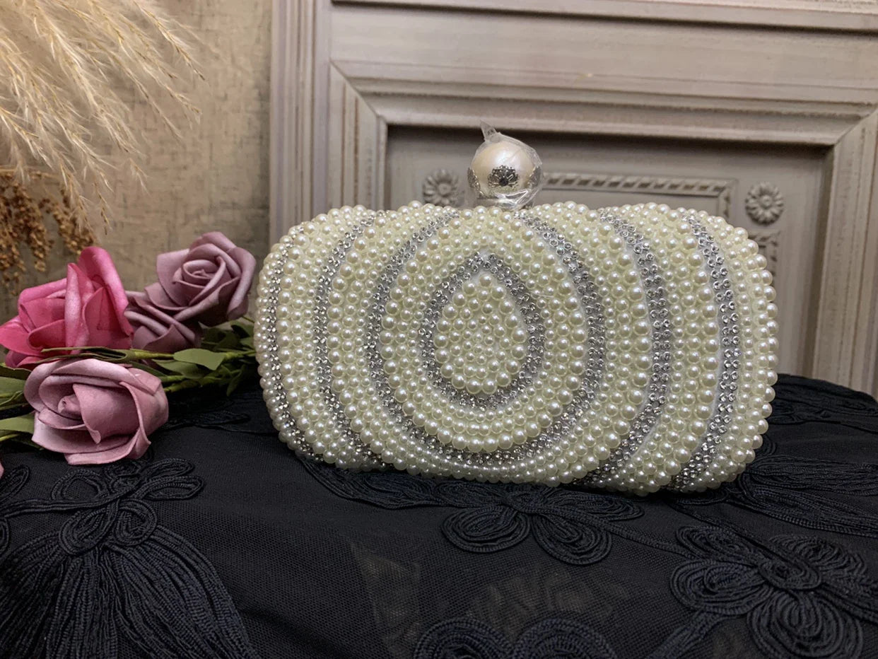 Sophisticated gold cheongsam handbag with pearlescent charm, a compact and stylish accessory for formal and casual occasions