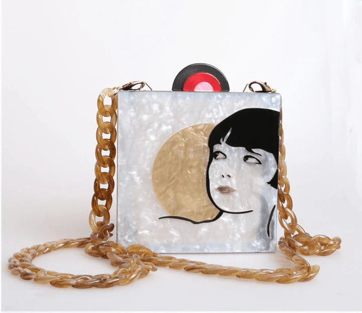Antique hand-stitched acrylic crossbody bag in a vintage style with a yellow chain strap, perfect for evening events or everyday use.