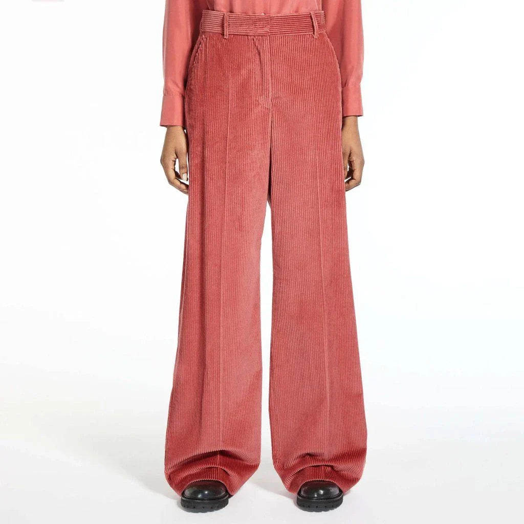 A pair of high-waist, wide-leg corduroy trousers in a classic red colour, designed for the modern British woman's wardrobe.