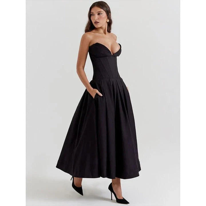 Elegant, backless A-line midi dress in black for women, featuring a sleek silhouette and sophisticated draping