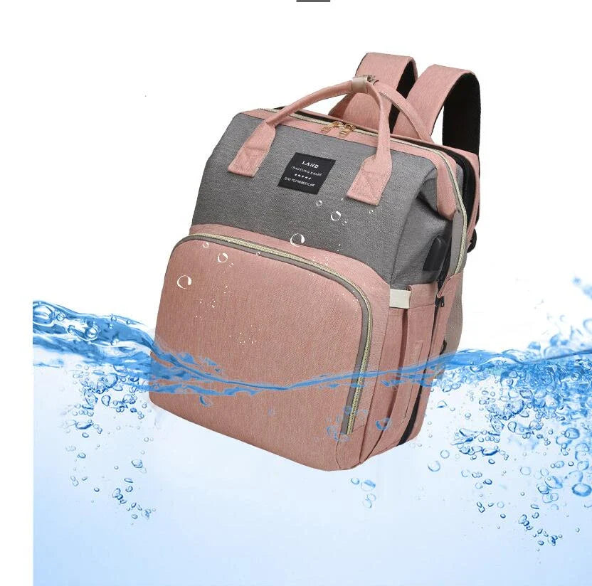 Multifunctional maternity diaper backpack with removable mosquito net, foldable crib, and water-resistant design for convenient family travel