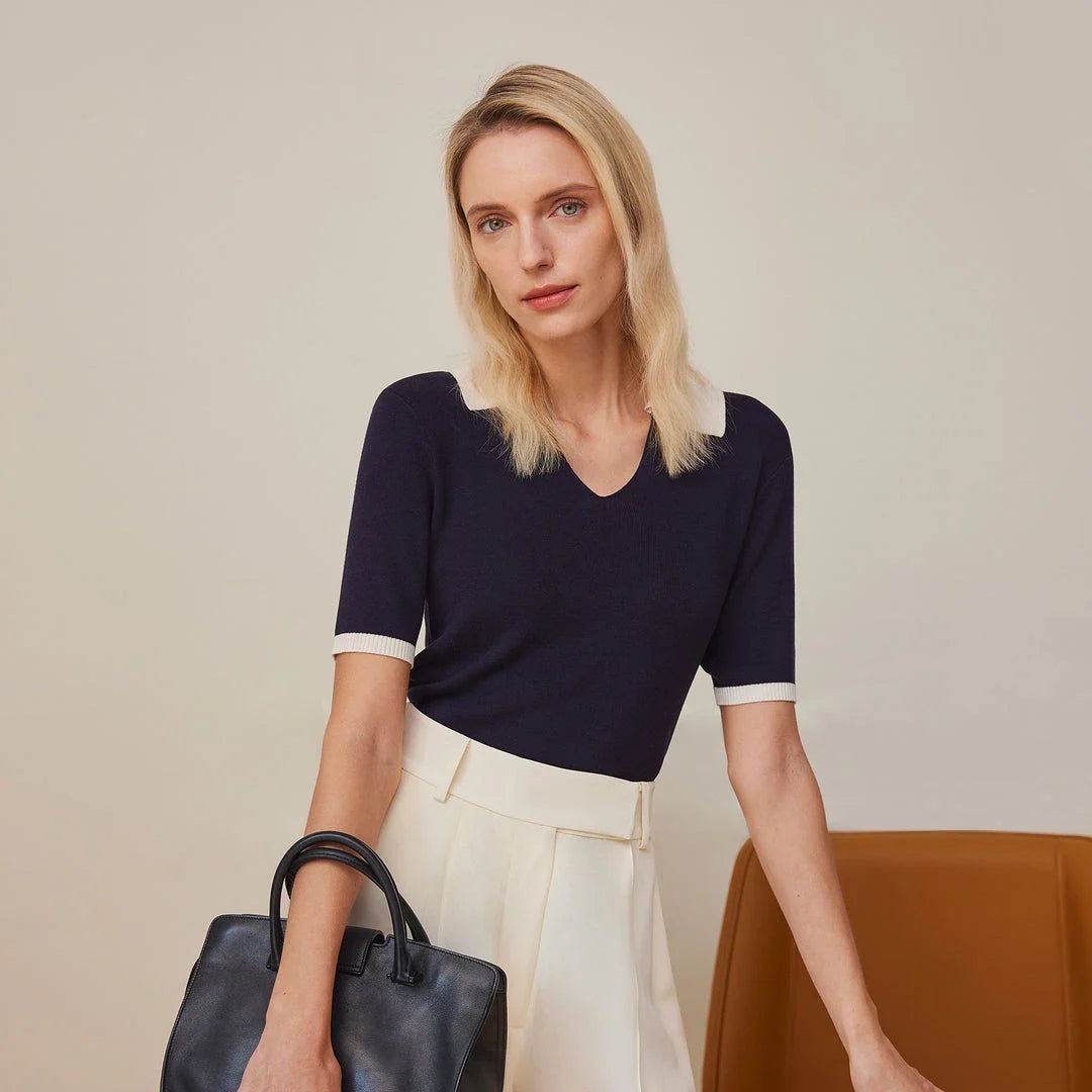 Stylish silk knit polo shirt in navy blue, featuring a slim fit design, contrasting trim, and a feminine v-neckline for refined British elegance.