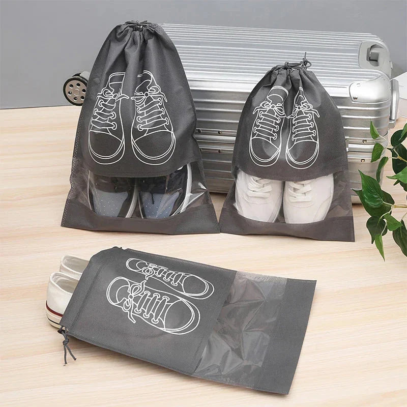 A set of grey travel shoe storage organiser bags with transparent panels for easy identification of contents