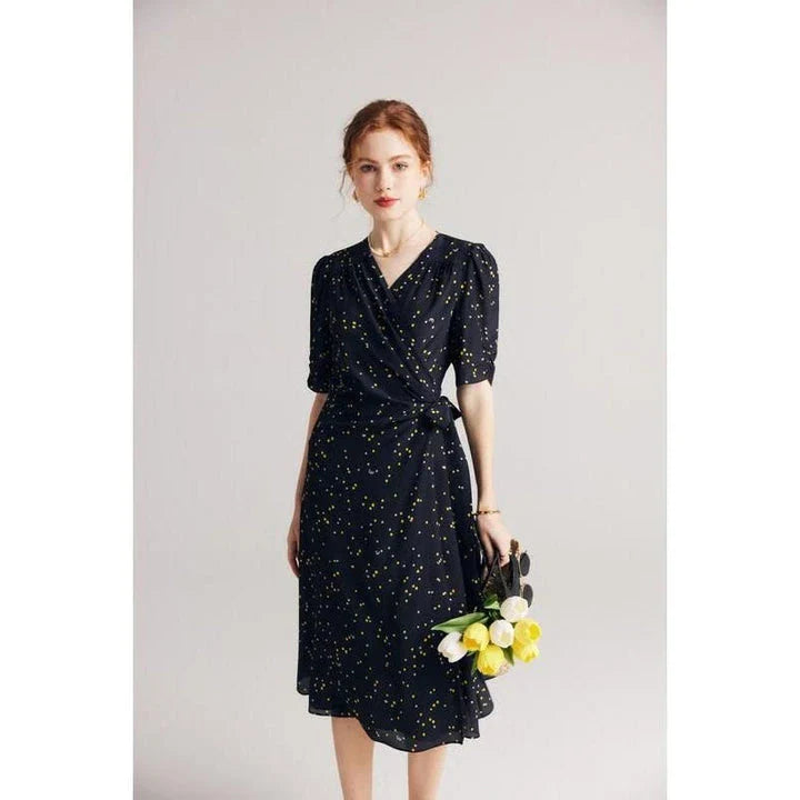 Sophisticated black polka dot silk wrap dress with a flattering V-neck and empire waistline, suitable for various occasions.