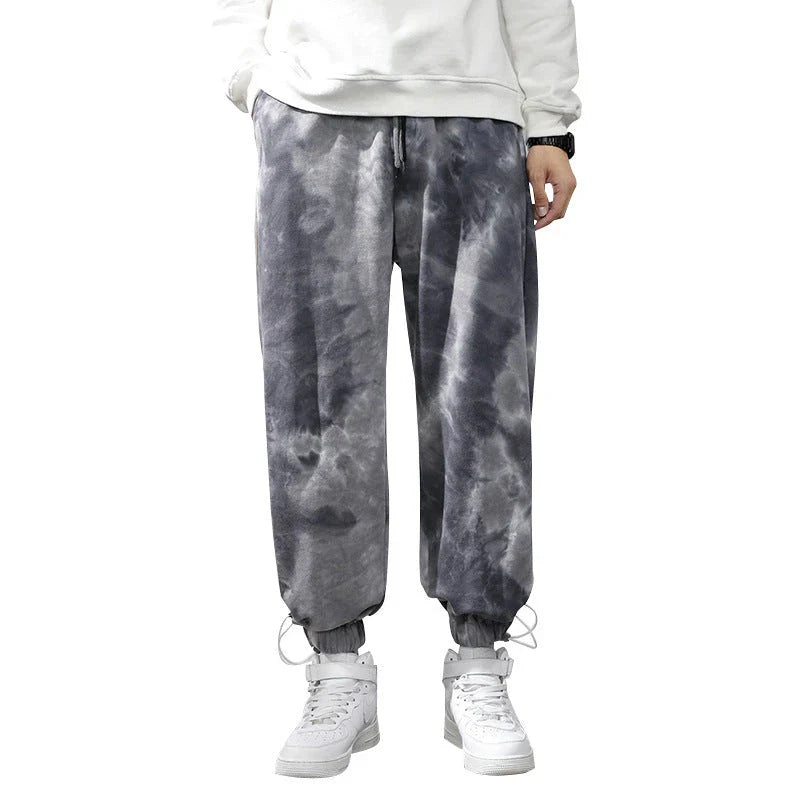 Stylish ankle-tied sweatpants in camouflage black, featuring an elasticated waistband, drawstring, and ankle ties for a relaxed yet refined look.