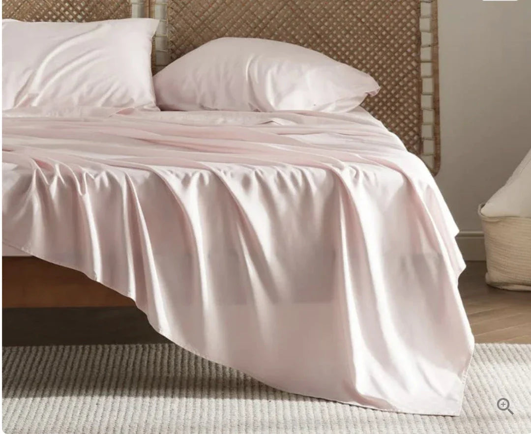 Premium bamboo fibre bed sheets in a classic solid purplish blue colour, featuring a four-piece set including a fitted sheet, flat sheet, and two pillowcases.