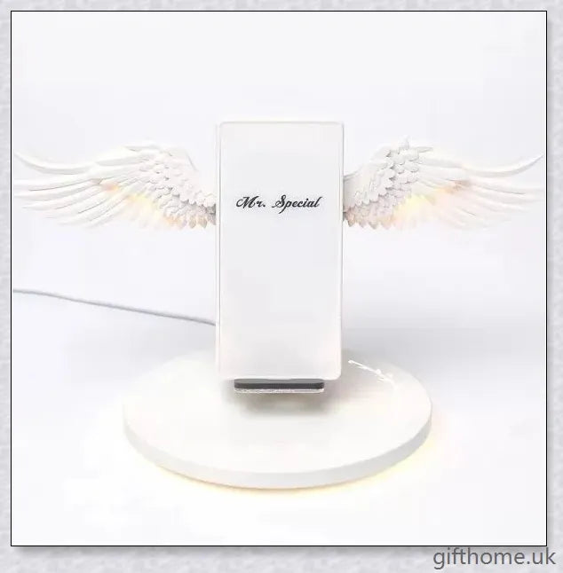 Elegant angel wings-shaped wireless charger with sleek, shiny surface and angelic lighting effect