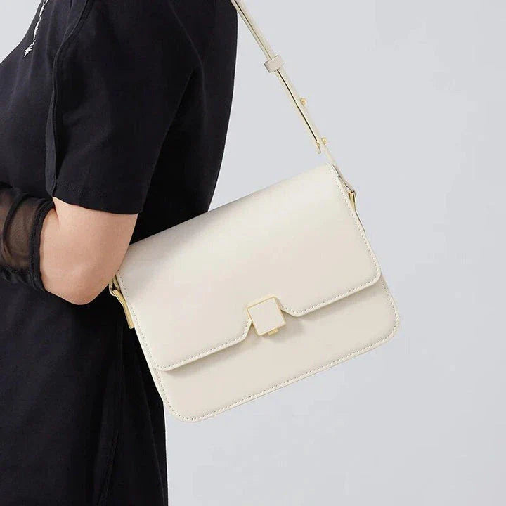 Stylish British-inspired leather shoulder and crossbody bag in black, tan, and navy colours