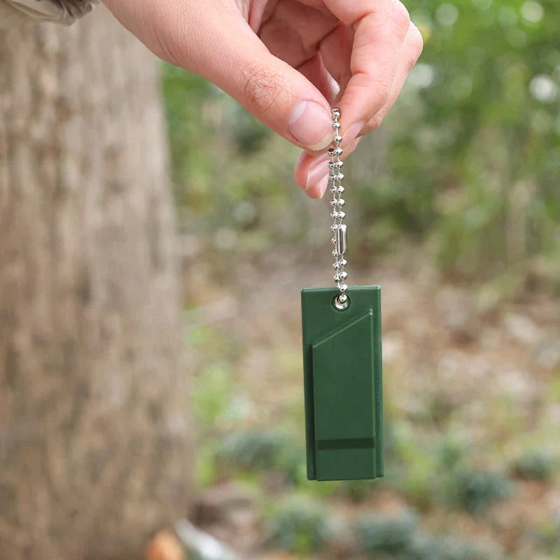 High-decibel outdoor survival whistle in dark green, made of durable polystyrene material for long-lasting use