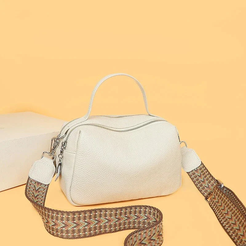 Luxurious genuine leather crossbody bag for women, featuring a soft polyester lining, dual phone pockets, and a compact, square design.