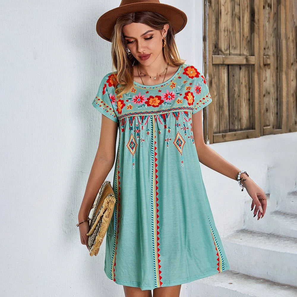 A stylish bohemian-inspired short dress with a geometric pattern, A-line silhouette, and short sleeves, suitable for warm weather