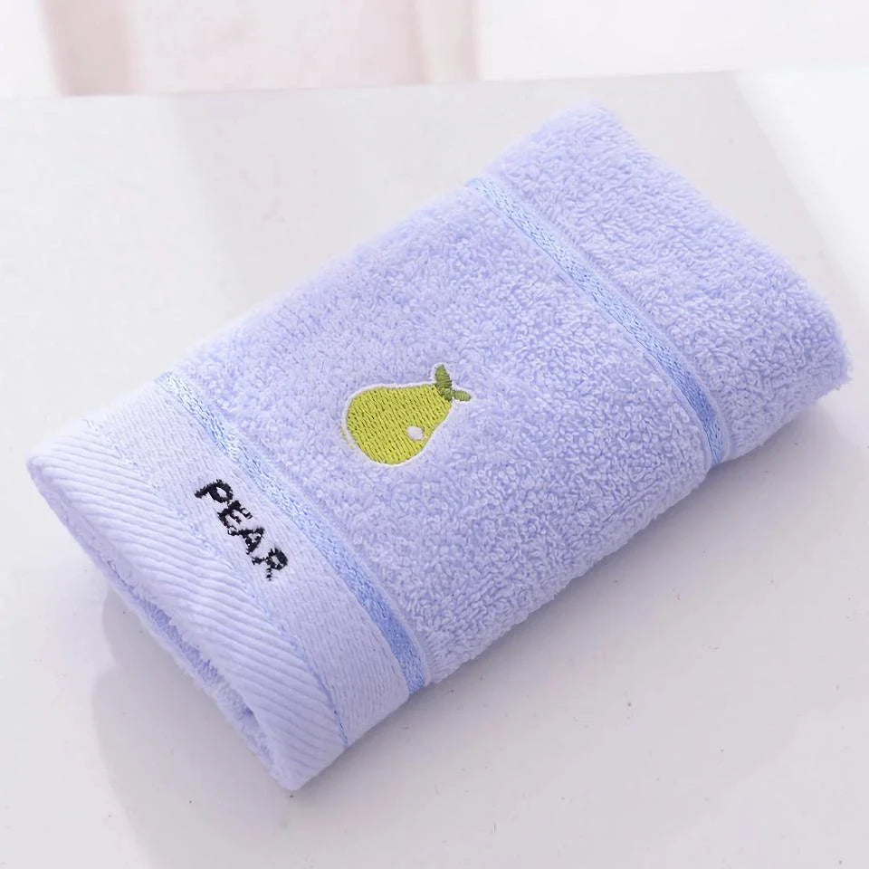 Soft cotton baby bath towel with adorable cartoon fruit face designs in pink