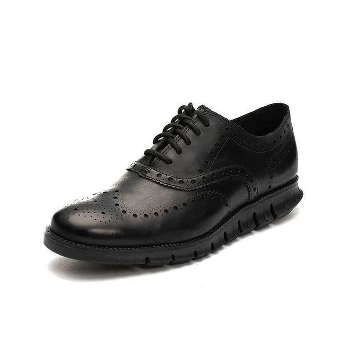 A pair of premium leather business shoes with a thick rubber sole and a stylish leather toe cap, available in brown and black colours.