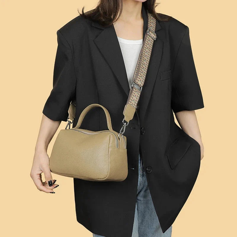 Luxurious genuine leather crossbody bag for women, featuring a soft polyester lining, dual phone pockets, and a compact, square design.