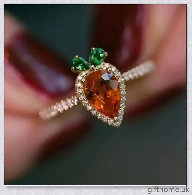 A close-up image of a charming copper ring with a carrot-shaped design and delicate micro-inlaid detailing.