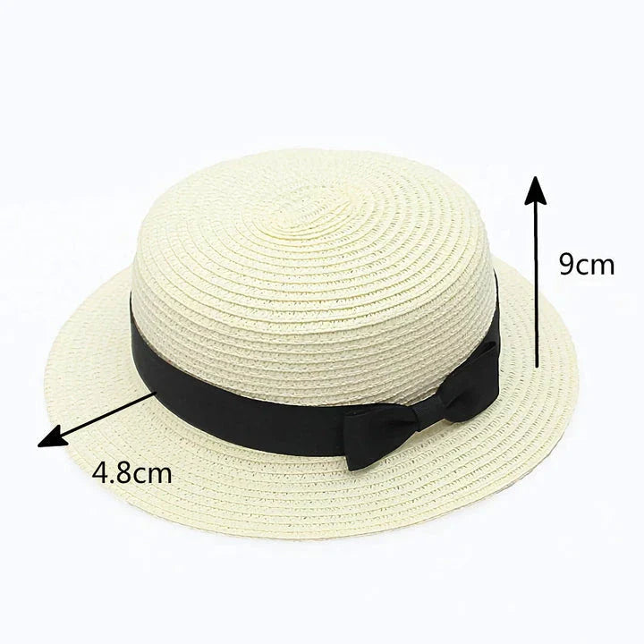 A classic summer Panama hat made from straw and paper, featuring a charming bow detail that adds a feminine touch.
