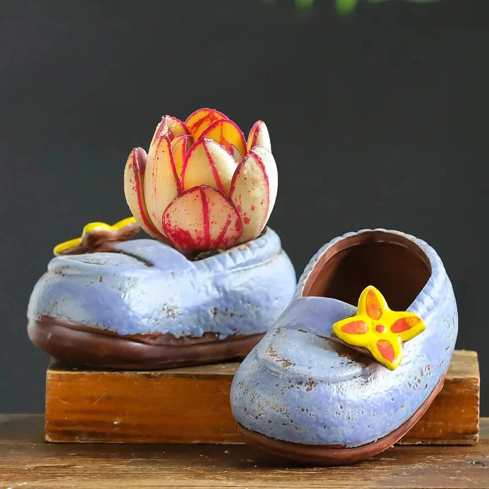 Charming ceramic boot-shaped vase with a glazed finish, perfect for displaying succulents and flowers in your home or garden
