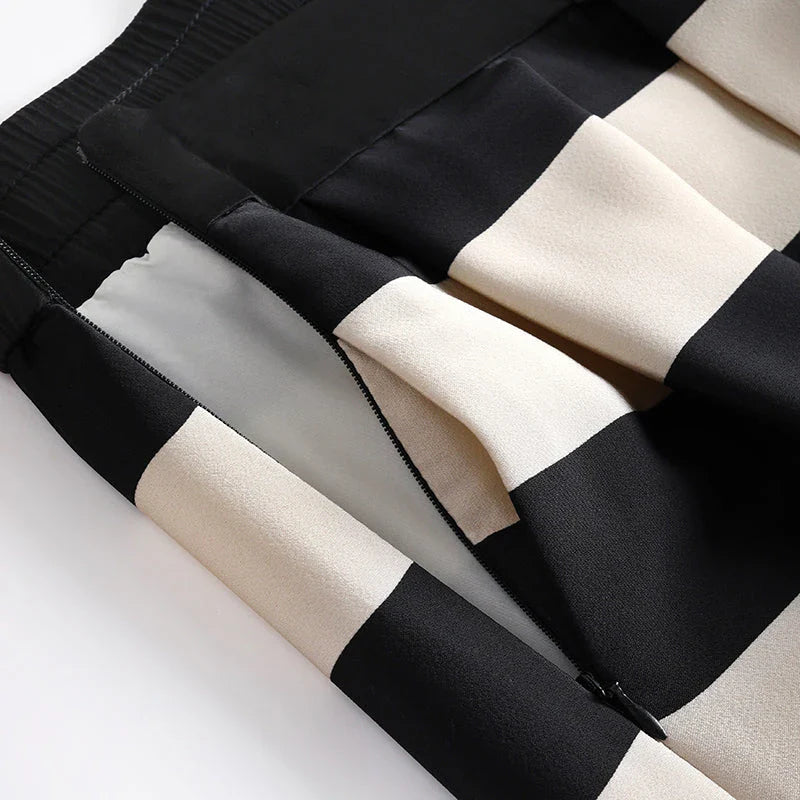 Elegant striped midi skirt with pleated design, made from premium polyester for a sophisticated and comfortable look.