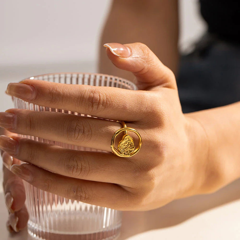 Elegant 18K gold-plated stainless steel ring with intricate hollow-carved design and vintage-inspired charm