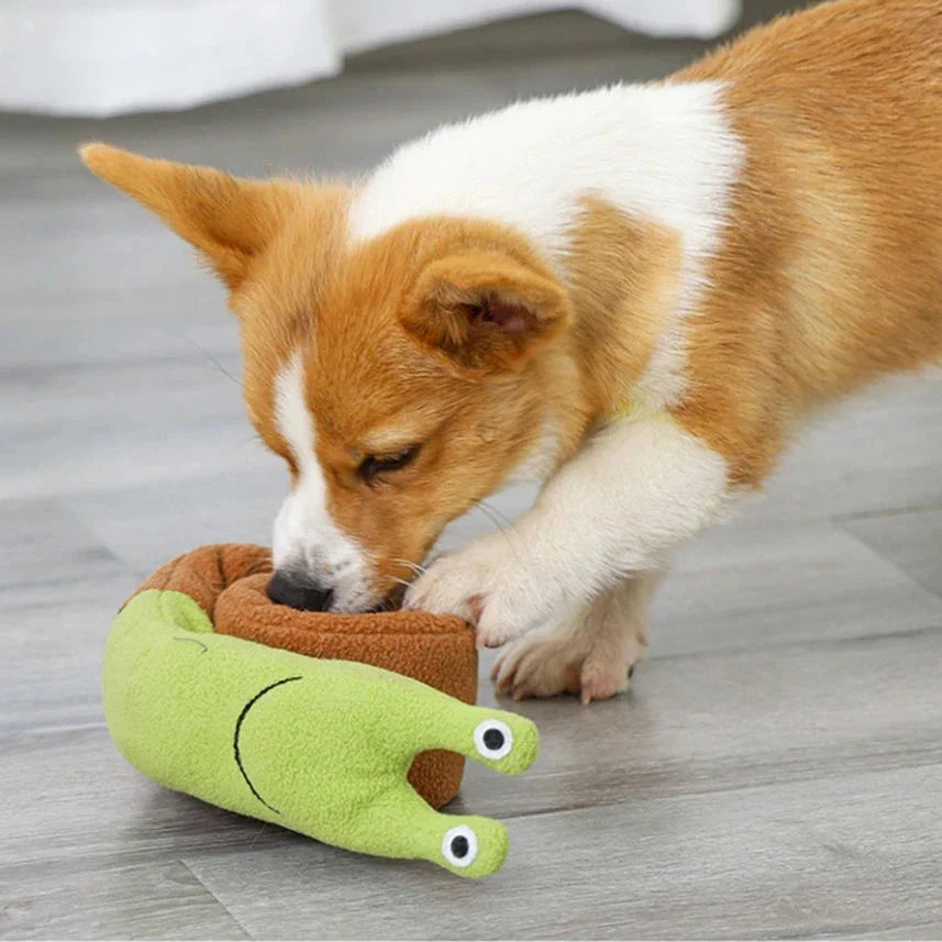 A plush snail-shaped snuffle mat toy with hidden treat pockets, designed to stimulate a dog's natural foraging instincts.