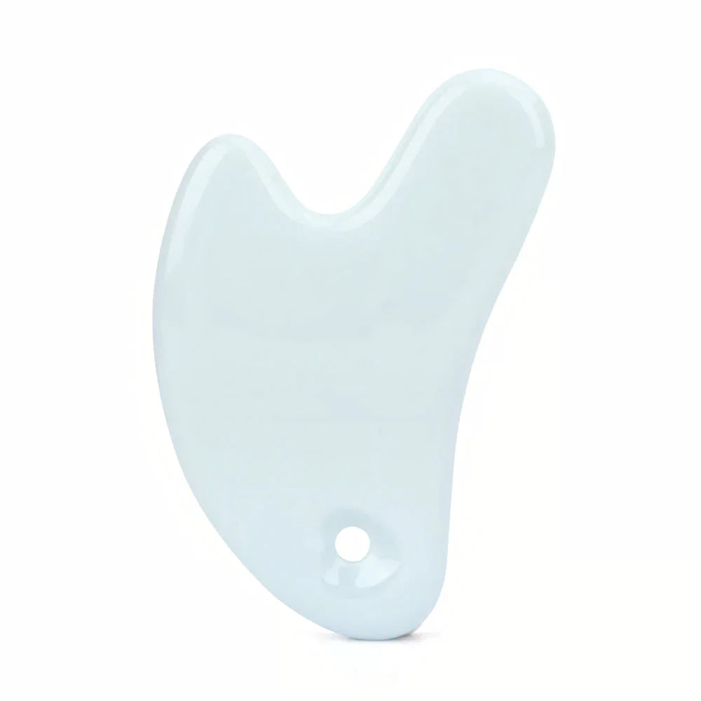 Ceramic Gua Sha facial massager in blue, pink, and white colours, designed to improve circulation and promote lymphatic drainage for radiant, youthful skin.