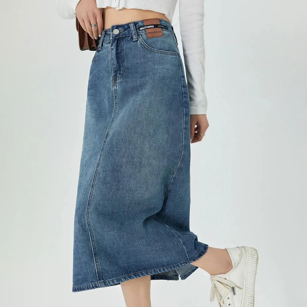 Classic blue A-line midi denim skirt with flattering empire waistline and flowy silhouette