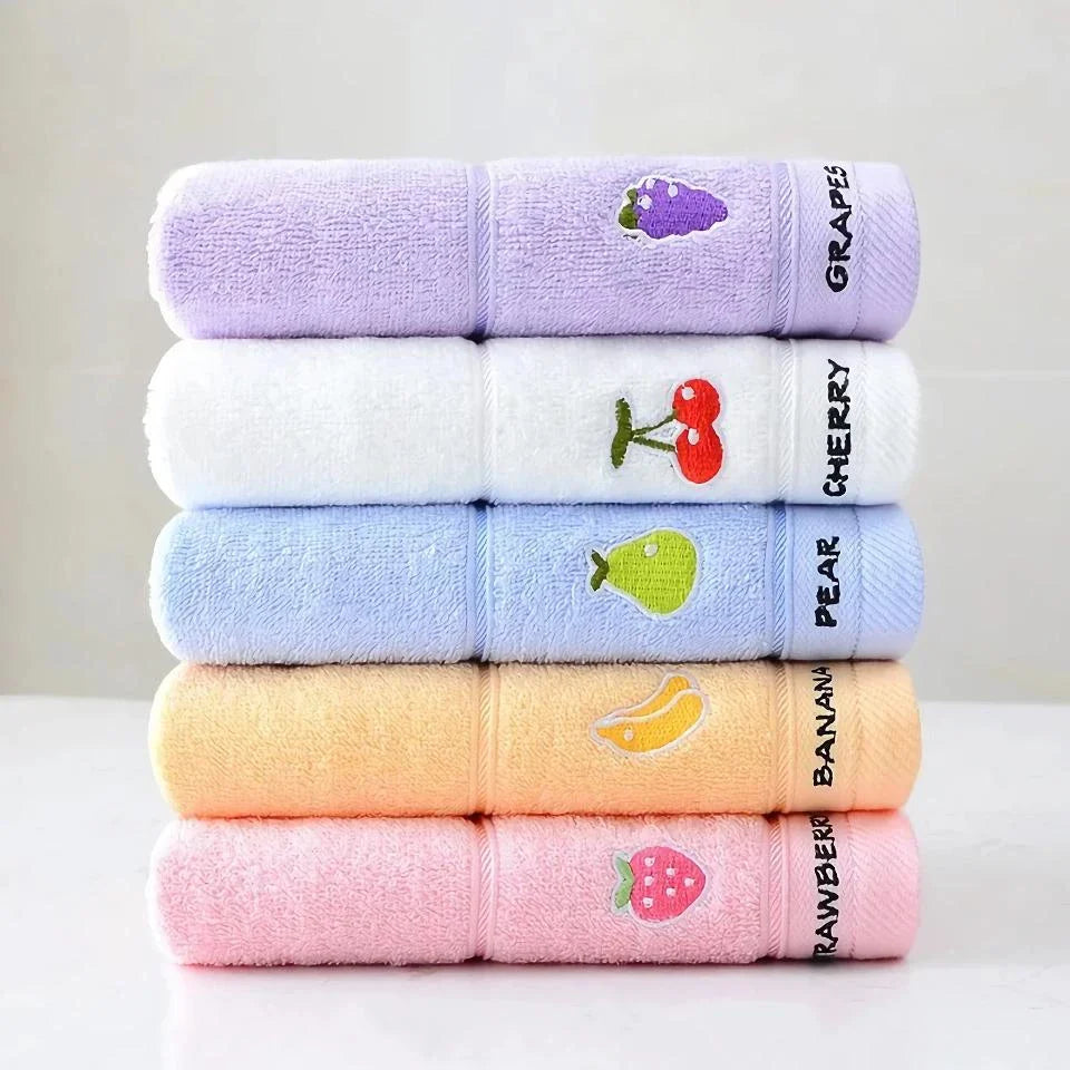 Soft cotton baby bath towel with adorable cartoon fruit face designs in pink