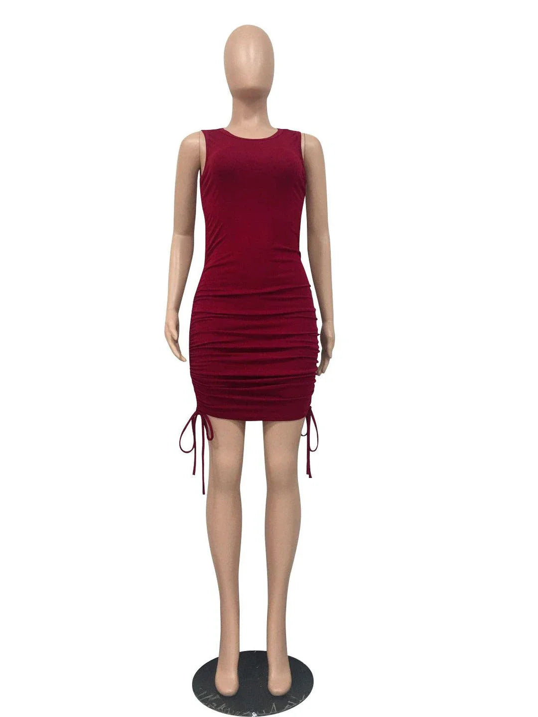 A stylish pleated dress with a drawstring waist, featuring a round neckline and conventional sleeves for a chic British fashion look.