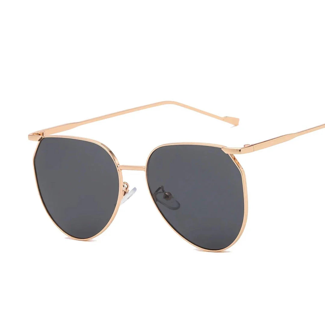 Elegant oval-shaped sunglasses with gradient lenses and alloy frames, offering timeless British style and UV protection.