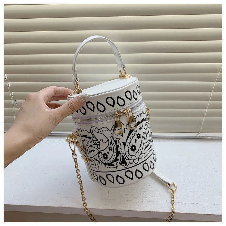Premium PU leather bucket bag in a variety of classic and contemporary colours, featuring a spacious main compartment, adjustable shoulder strap, and sophisticated British-inspired design.