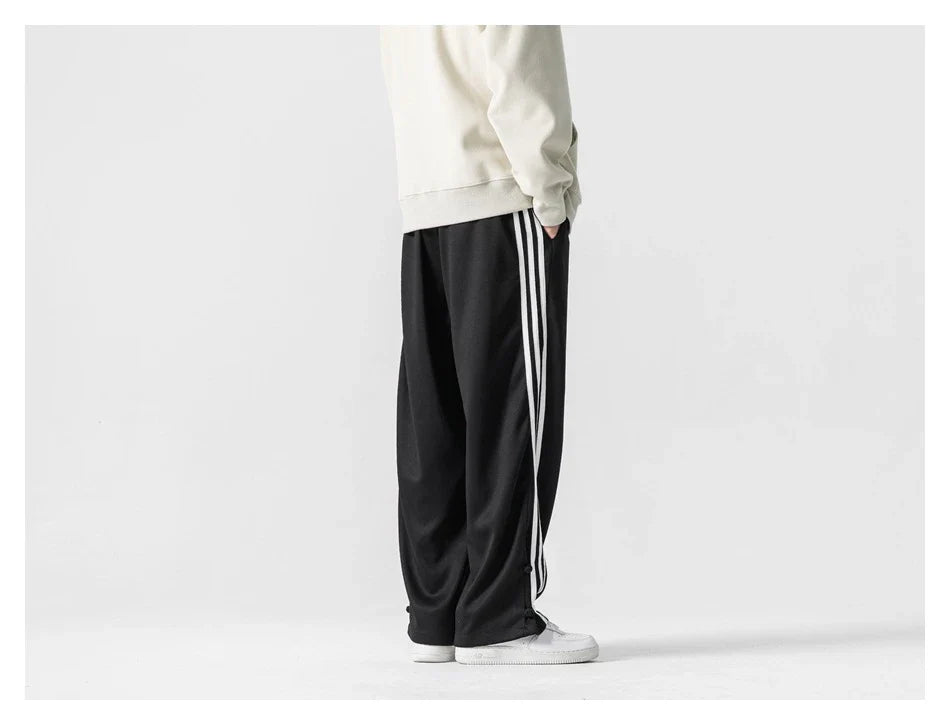 Stylish striped sports trousers in a relaxed, mid-waist design for versatile leisure and athletic wear