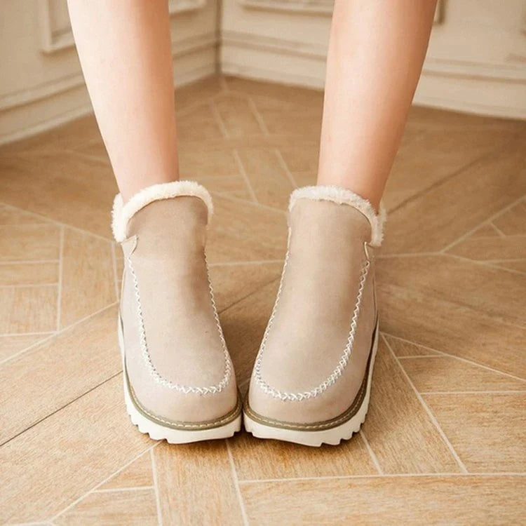 A pair of stylish, non-slip snow boots with a warm artificial wool lining, perfect for British winter weather