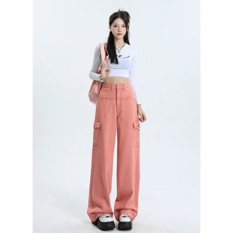 A pair of pink high-waist baggy jeans with a straight-leg design, featuring vintage-inspired details like buttons and faux zippers.