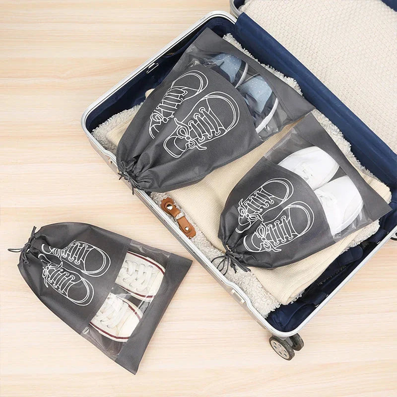 A set of grey travel shoe storage organiser bags with transparent panels for easy identification of contents