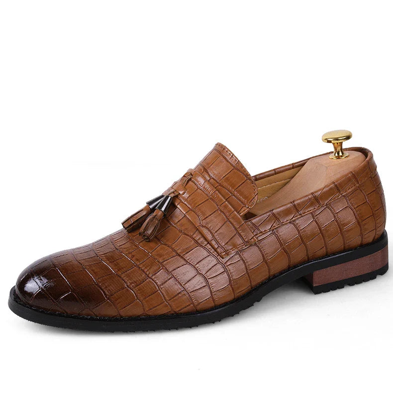 Premium British-crafted men's pointed leather dress shoes with tassels in black color