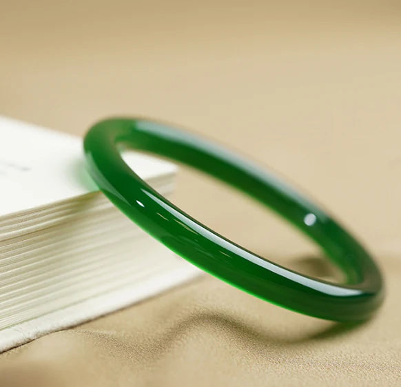Stylish agate chalcedony bracelet with jingle bell charm in classic green hues